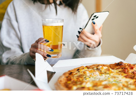 Women having an online drinking party at home 73717428