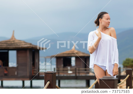 Woman in white blouse on resort 73717585