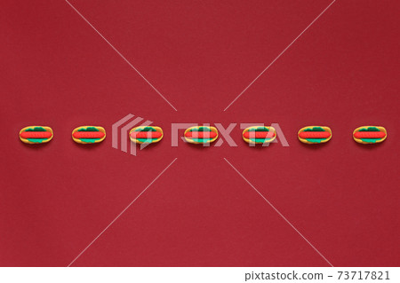 Many small hot dogs on a red background 73717821