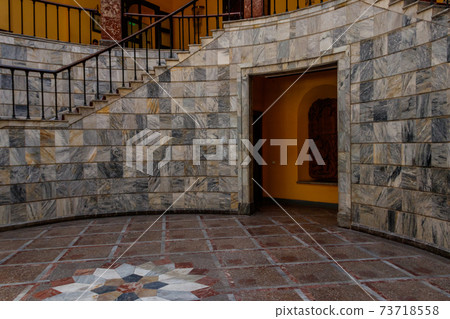 Staircase covered with red carpet in a lobby Staircase covered with red carpet in a lobby 73718558