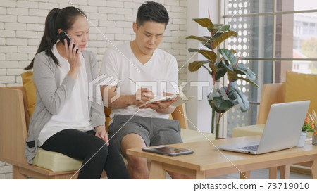 family couple husband and wife working confirming booking having talking call phone family couple husband and wife working confirming booking having talking call phone 73719010