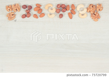 Various nuts and almonds containing healthy natural vitamins and minerals, nutritious eating 73720799