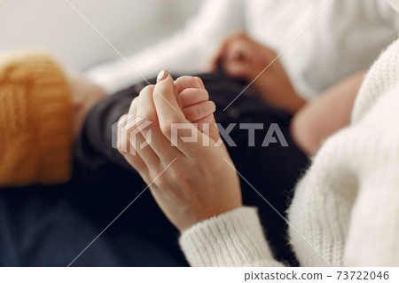 Elegant grandma at home with daughter and grandson 73722046