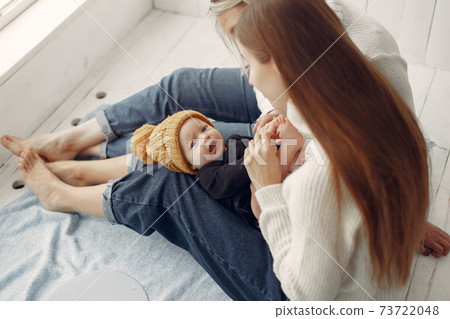 Elegant grandma at home with daughter and grandson 73722048