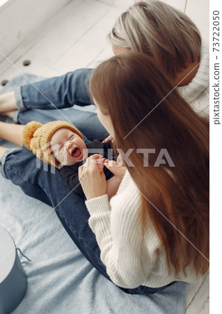 Elegant grandma at home with daughter and grandson Elegant grandma at home with daughter and grandson 73722050