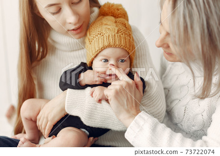 Elegant grandma at home with daughter and grandson Elegant grandma at home with daughter and grandson 73722074