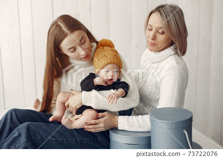 Elegant grandma at home with daughter and grandson Elegant grandma at home with daughter and grandson 73722076