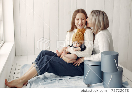 Elegant grandma at home with daughter and grandson Elegant grandma at home with daughter and grandson 73722078