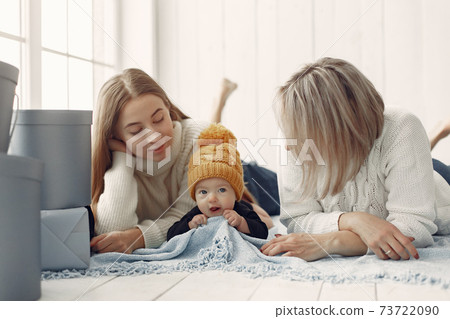 Elegant grandma at home with daughter and grandson 73722090