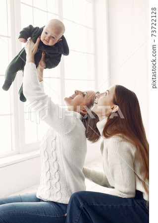 Elegant grandma at home with daughter and granddaughter Elegant grandma at home with daughter and granddaughter 73722128
