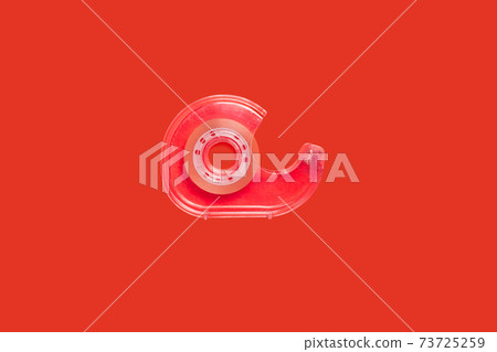 pink scotch tape dispenser isolated on red background 73725259