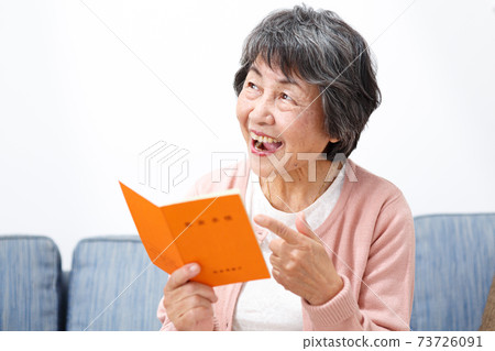 Senior woman with a pension book Senior woman with a pension book 73726091