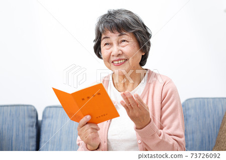Senior woman with a pension book Senior woman with a pension book 73726092