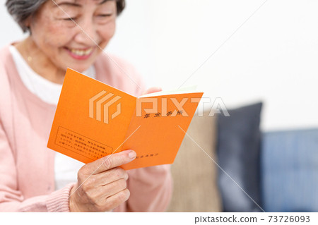 Senior woman with a pension book Senior woman with a pension book 73726093