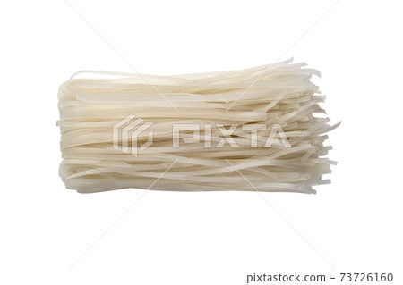 Rice noodles on a white background. Dry rice noodles close up on a white background. 73726160