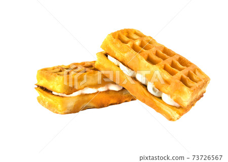 Soft waffles with a filling. Two waffles with a cream filling on a white background. Soft waffles with a filling. Two waffles with a cream filling on a white background. 73726567