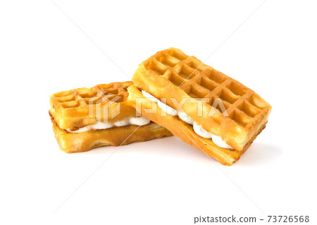 Soft waffles with a filling. Two waffles with a cream filling on a white background. Soft waffles with a filling. Two waffles with a cream filling on a white background. 73726568