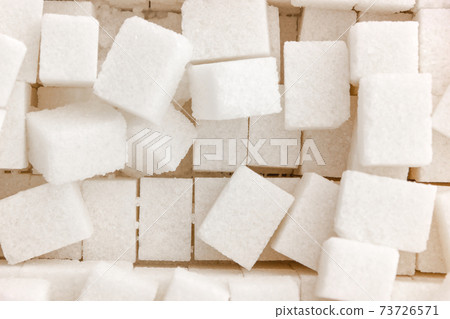 Cubes of sugar on a white background. Many cubes of sugar close-up. 73726571