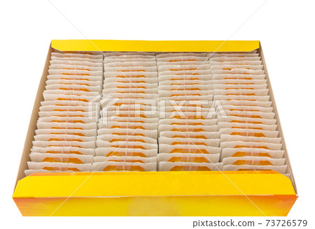 Tea bags in the box. Many tea bags folded in a box on a white background. 73726579