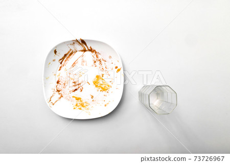 food plates and drinking glasses on white background after eatin 73726967