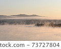 Water mist rising from the river on a winter morning 73727804