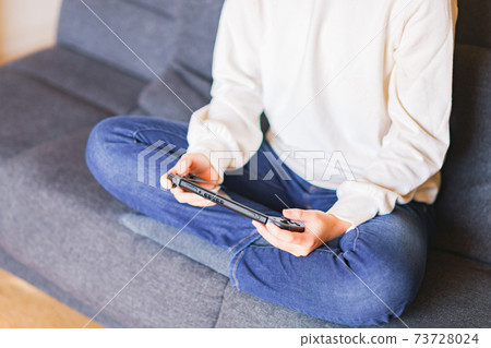 Teenager playing with a game controller [e-sports] 73728024