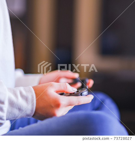 Teenager playing with a game controller [e-sports] 73728027
