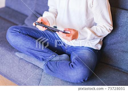 Teenager playing with a game controller [e-sports] 73728031