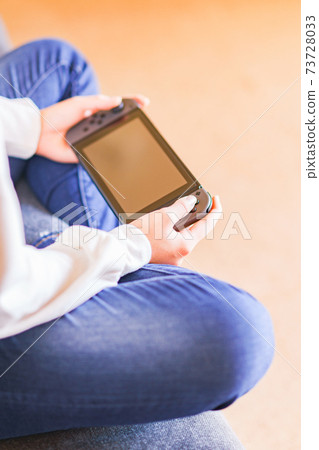 Teenager playing with a game controller [e-sports] 73728033
