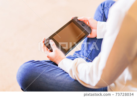 Teenager playing with a game controller [e-sports] 73728034