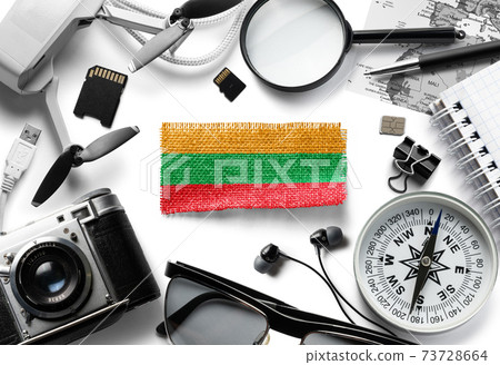Flag of Lithuania and travel accessories on a white background. 73728664