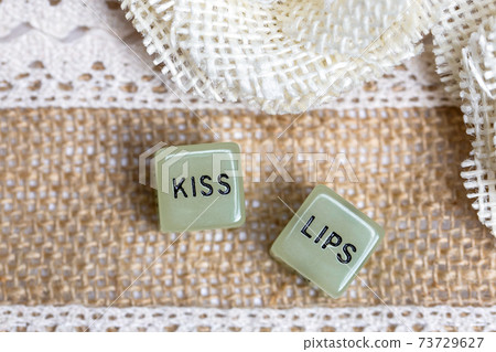 Two erotic dice for sexual game with cotton lace background texture, with the text Kiss lips for Valentines Day,sex,sensual,romantic, love concept Two erotic dice for sexual game with cotton lace background texture, with the text Kiss lips for Valentines Day,sex,sensual,romantic, love concept 73729627