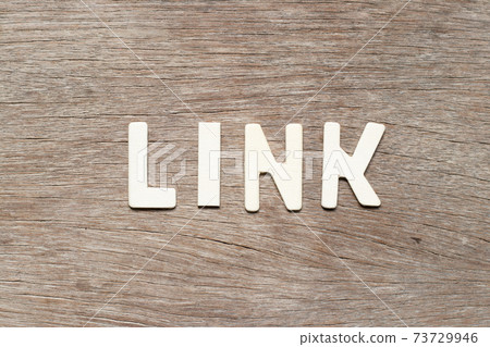 Alphabet letter in word link on wood background Alphabet letter in word link on wood background 73729946