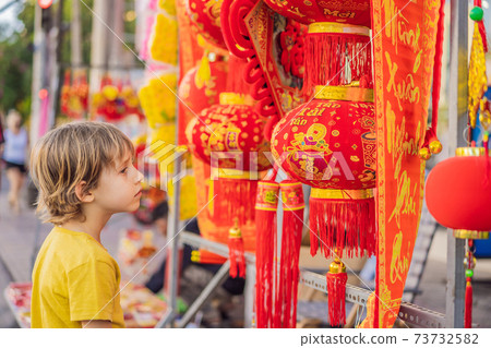 Caucasian tourist boy in Tet holidays. Vietnam Chinese Lunar New Year in springtime TEXT TRANSLATION from Vietnamese: Congratulations on the Vietnamese, Chinese New Years and wishes of all the best in Caucasian tourist boy in Tet holidays. Vietnam Chinese Lunar New Year in springtime TEXT TRANSLATION from Vietnamese: Congratulations on the Vietnamese, Chinese New Years and wishes of all the best in 73732582