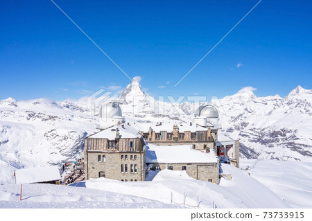 The observatory on Gornergrat Summit overlooking Matterhorn as background in Zermatt, an iconic emblem of the Swiss Alps in canton Valais, Switzerland 73733915