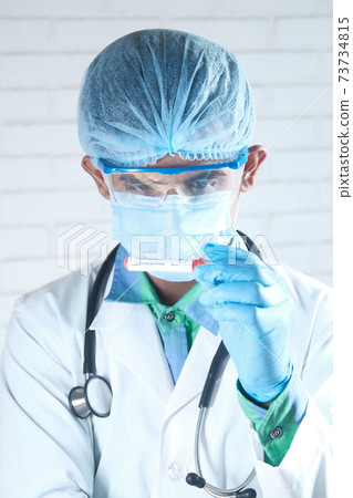 young labradorian's hand in blue medical gloves holding blood test tube young labradorian's hand in blue medical gloves holding blood test tube 73734815