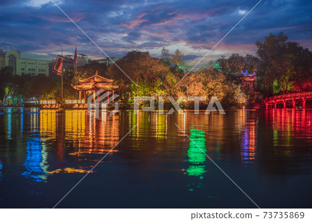 Hanoi Red Bridge at night. The wooden red-painted bridge over the Hoan Kiem Lake connects the shore and the Jade Island on which Ngoc Son Temple stands 73735869
