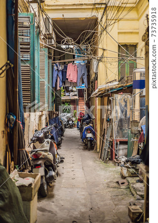 Street scene from a narrow alley in the old quarter in Hanoi. Streets and guilds of the old quarter are a major tourist attraction 73735918