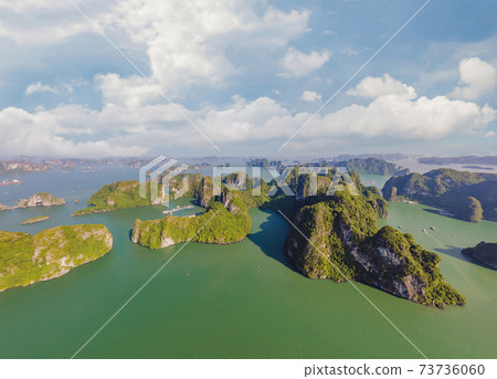 Aerial view panorama of floating fishing village and rock island, Halong Bay, Vietnam, Southeast Asia. UNESCO World Heritage Site. Junk boat cruise to Ha Long Bay. Popular landmark of Vietnam 73736060