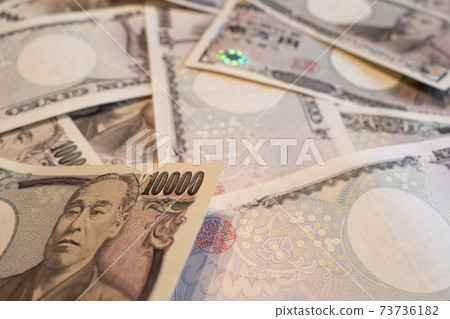 Money of 10,000 yen bills spread on the desk Money of 10,000 yen bills spread on the desk 73736182