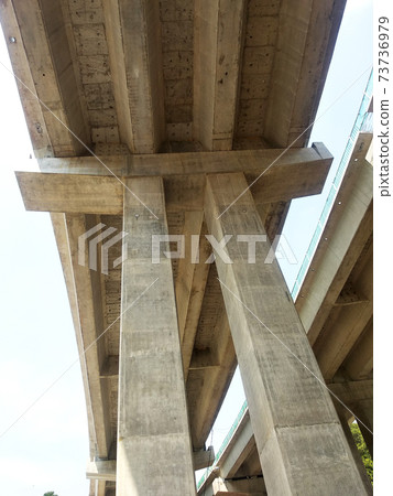 PENANG, MALAYSIA - MARCH 21, 2020: Overhead road under construction. The massive concrete column used to support the concrete road deck. Construction work is in full swing. 73736979