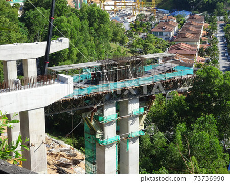 PENANG, MALAYSIA - MARCH 21, 2020: Overhead road under construction. The massive concrete column used to support the concrete road deck. Construction work is in full swing. 73736990