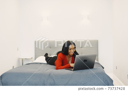 African woman spend time at home African woman spend time at home 73737428