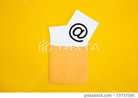 Envelope with email symbol on yellow background Envelope with email symbol on yellow background 73737595