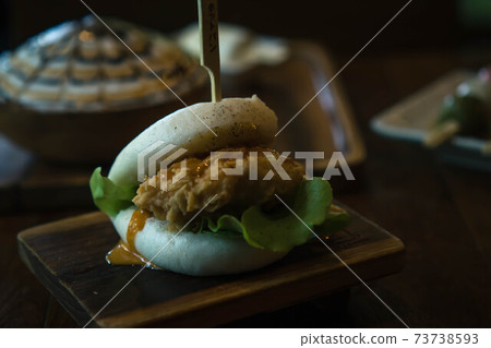 Selective focus Hirata Buns. Japanese traditional food. Asian cuisine made from steamed buns stuffed with salad and delicious savory fillings, sandwiches or tacos Selective focus Hirata Buns. Japanese traditional food. Asian cuisine made from steamed buns stuffed with salad and delicious savory fillings, sandwiches or tacos 73738593