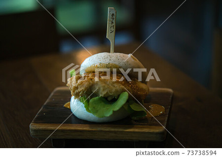 Selective focus Hirata Buns. Japanese traditional food. Asian cuisine made from steamed buns stuffed with salad and delicious savory fillings, sandwiches or tacos Selective focus Hirata Buns. Japanese traditional food. Asian cuisine made from steamed buns stuffed with salad and delicious savory fillings, sandwiches or tacos 73738594