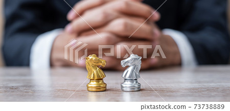 Gold and silver Chess Knight (horse) figure with businessman manager background. Strategy, Conflict, management, business planning, tactic, politic, communication and leader concept Gold and silver Chess Knight (horse) figure with businessman manager background. Strategy, Conflict, management, business planning, tactic, politic, communication and leader concept 73738889