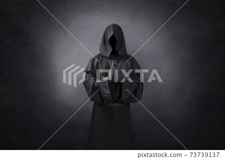 Ghostly figure praying in the dark Ghostly figure praying in the dark 73739137