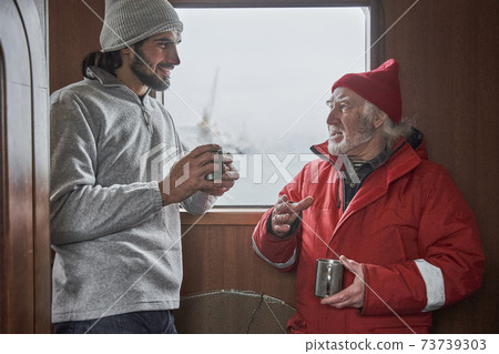 Colleagues discussing difficult issues calmly during coffee break Colleagues discussing difficult issues calmly during coffee break 73739303