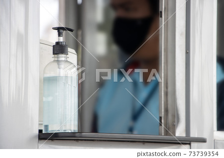 The bottle of disinfectant stands on the counter at the operator. The bottle of disinfectant stands on the counter at the operator. 73739354